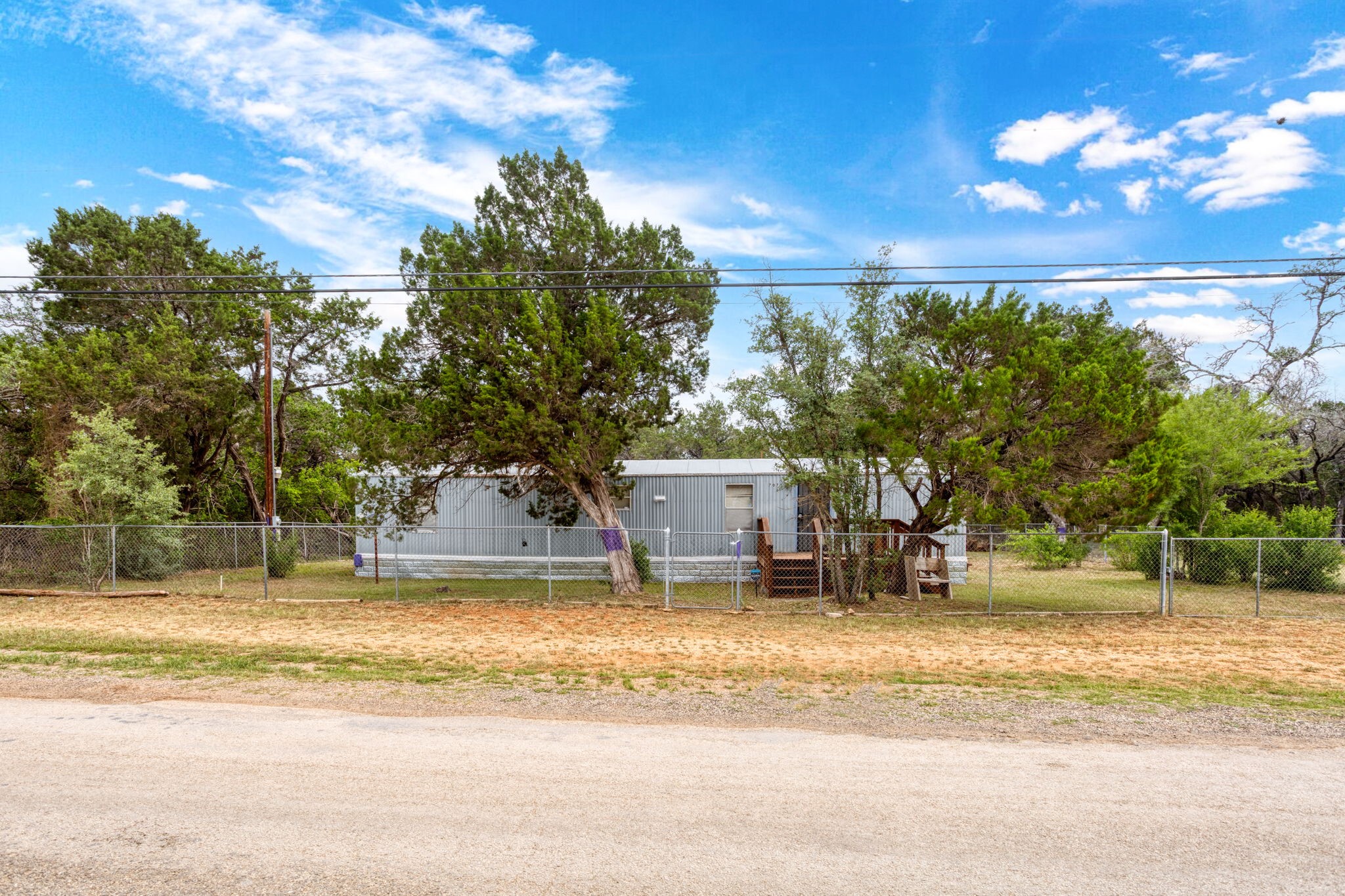 7075 Whartons Dock Road Bandera, TX 78003 - Photo 2 of 19 a view of a house with a yard