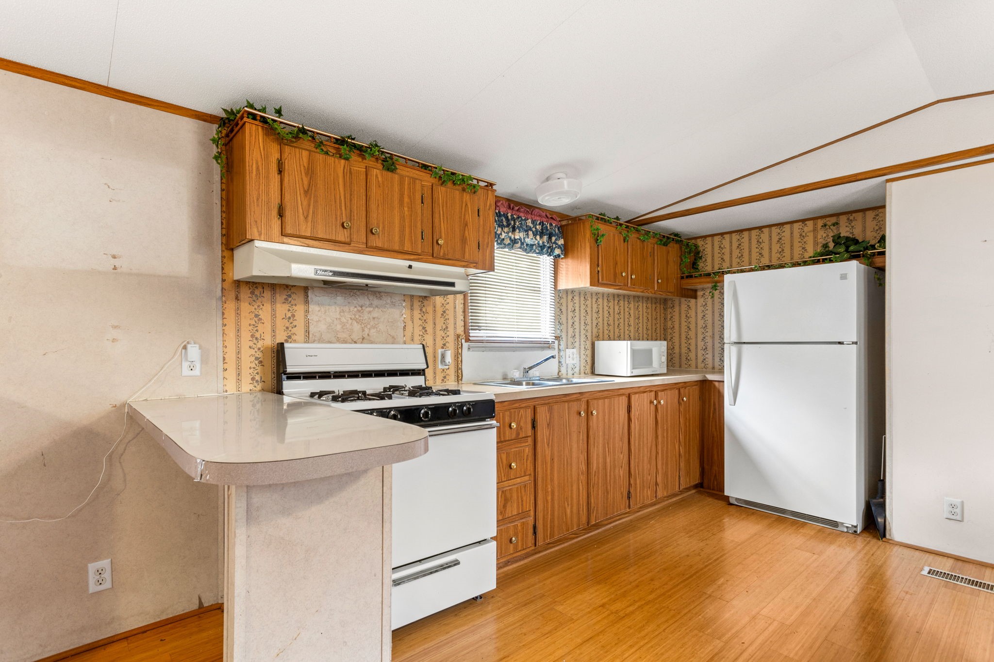 7075 Whartons Dock Road Bandera, TX 78003 - Photo 7 of 19 a kitchen with granite countertop a refrigerator stove and sink