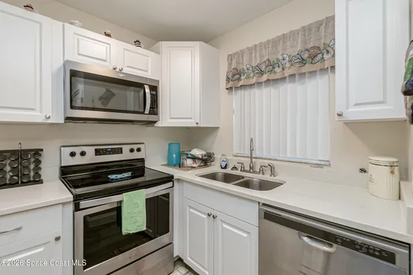 a kitchen with cabinets stainless steel appliances and a sink