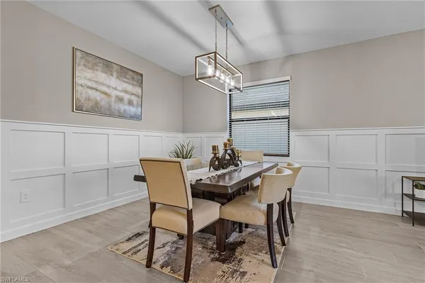 a view of a dining room with furniture and wooden floor