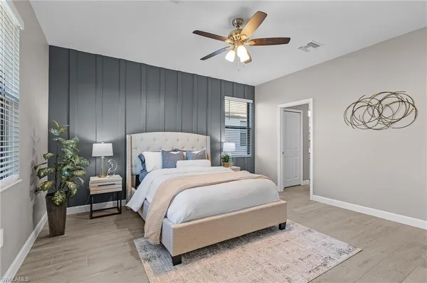 a bedroom with a bed and a chandelier