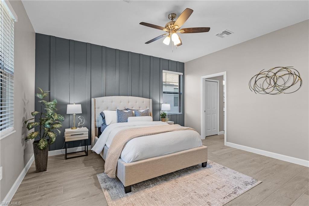 20716 Napa Loop Estero, FL 33928 - Photo 13 of 50 a bedroom with a bed and a chandelier