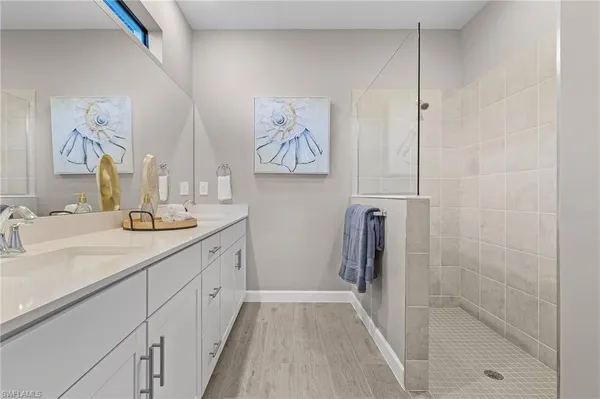 a spacious bathroom with a double vanity sink and a mirror