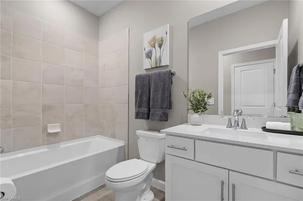 a bathroom with a sink a toilet and bathtub
