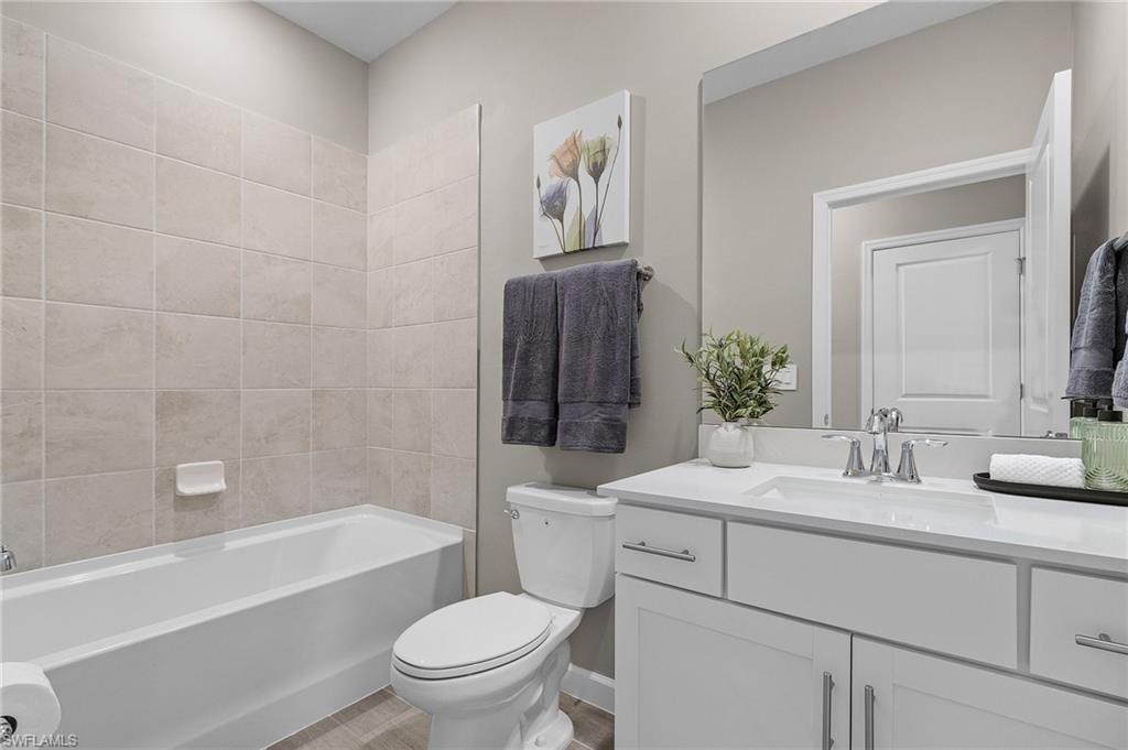 20716 Napa Loop Estero, FL 33928 - Photo 17 of 50 a bathroom with a sink a toilet and bathtub