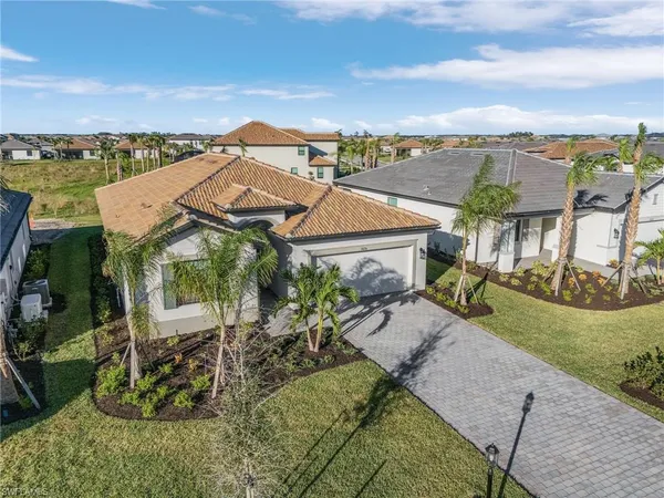 an aerial view of a house with a yard and lake view