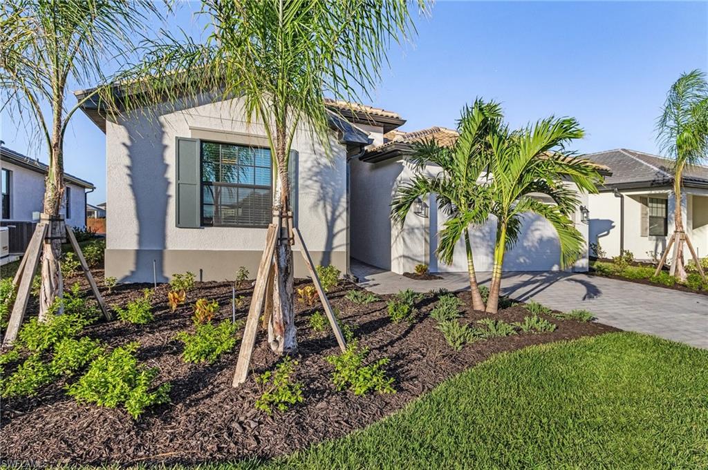 20716 Napa Loop Estero, FL 33928 - Photo 3 of 50 a front view of a house with garden