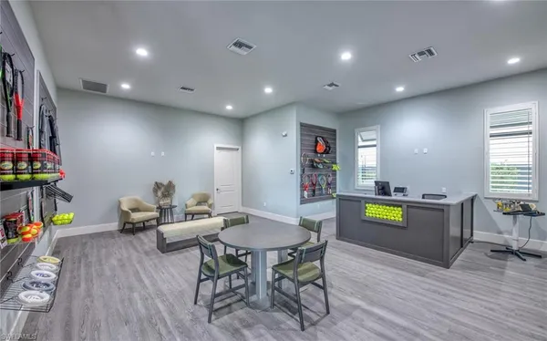 a view of a patio with chairs and table under an umbrella