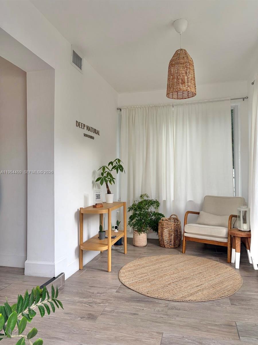 a living room with furniture and flowers