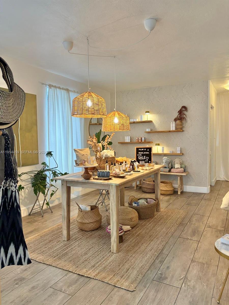 555 Northeast 70th Street Miami, FL 33138 - Photo 2 of 14 a living room with dining table and chairs