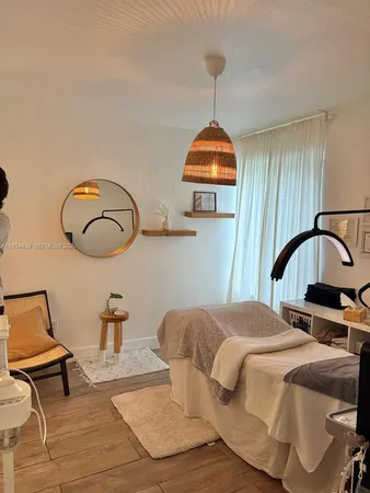 a bedroom with bed and a chandelier