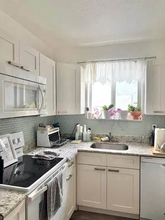 a kitchen with cabinets a sink and a stove