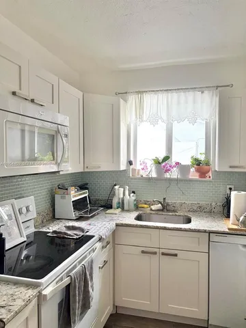 a kitchen with cabinets a sink and a stove