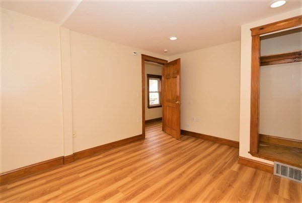 24 Elm Street Boston, MA 02136 - Photo 11 of 27 a view of an empty room with wooden floor and a window
