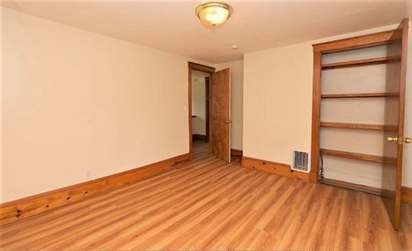 24 Elm Street Boston, MA 02136 - Photo 12 of 27 a view of an empty room with wooden floor and a window