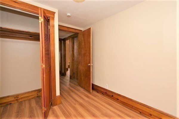 24 Elm Street Boston, MA 02136 - Photo 15 of 27 a view of a hallway with wooden floor and staircase