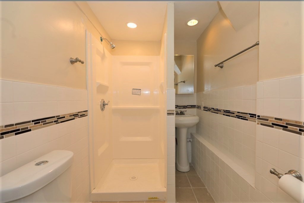 24 Elm Street Boston, MA 02136 - Photo 5 of 27 a bathroom with a shower a toilet and sink