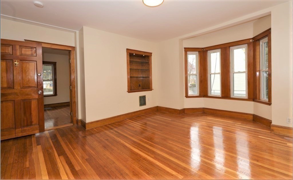 24 Elm Street Boston, MA 02136 - Photo 9 of 27 a view of empty room with wooden floor and fan