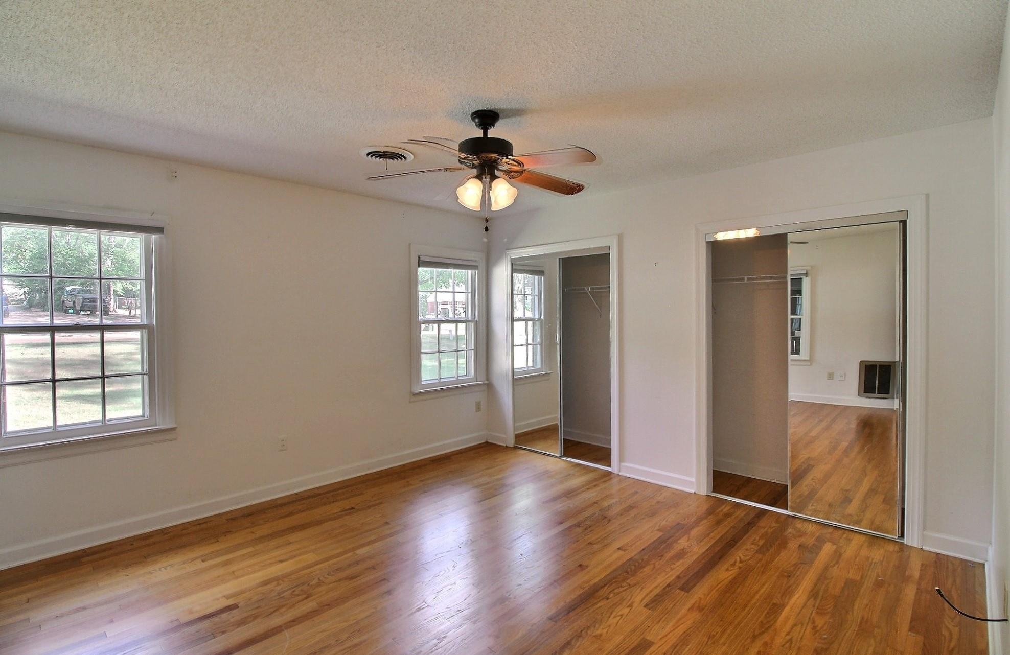 487 South Center Street Collierville, TN 38017 - Photo 11 of 25 a view of an empty room with wooden floor and a window