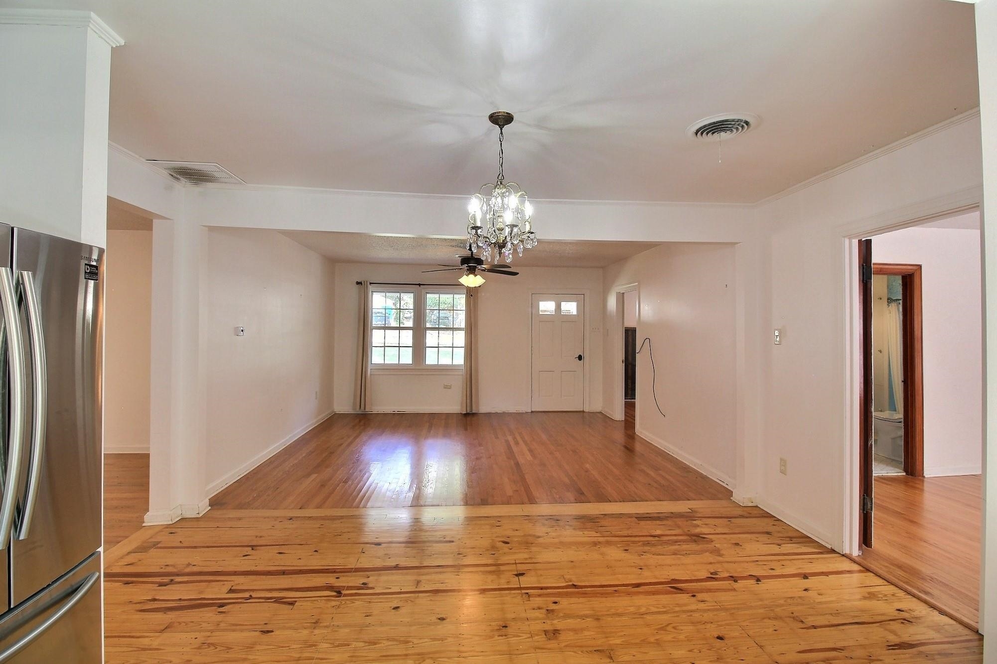 487 South Center Street Collierville, TN 38017 - Photo 15 of 25 a view of a livingroom with a chandelier fan and windows