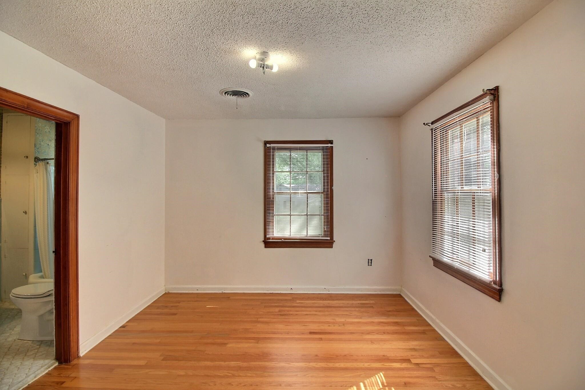 487 South Center Street Collierville, TN 38017 - Photo 18 of 25 a view of an empty room with wooden floor and a window