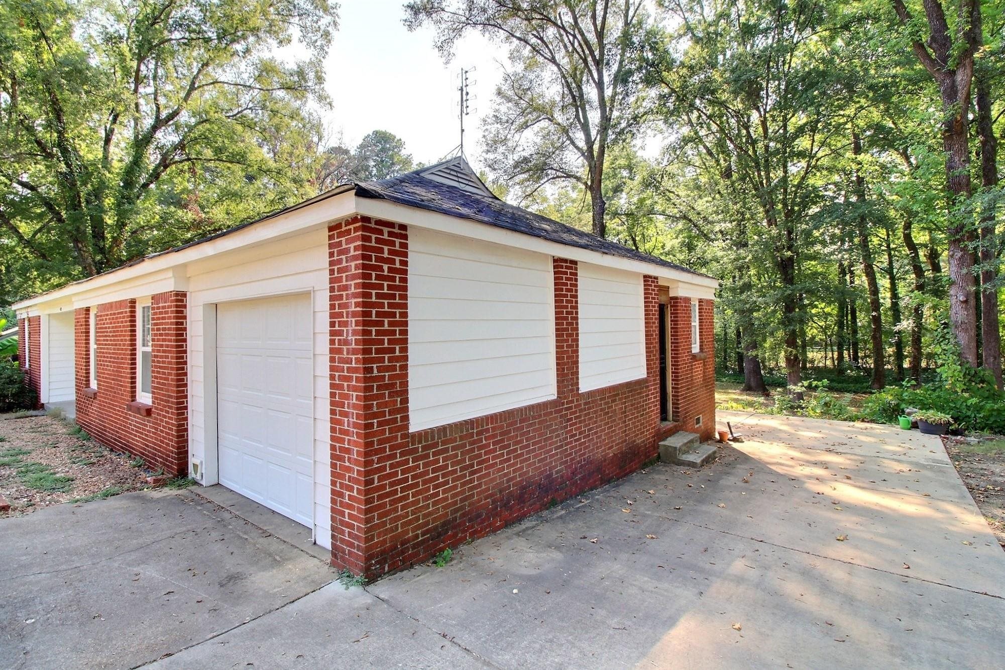487 South Center Street Collierville, TN 38017 - Photo 2 of 25 a view of a house with a yard and garage