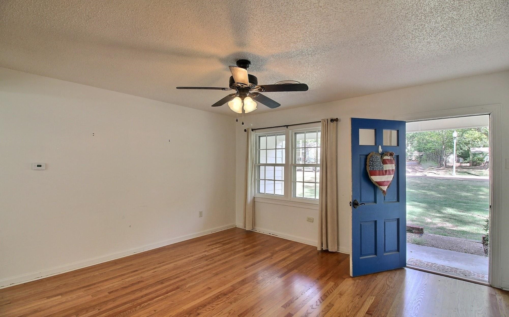 487 South Center Street Collierville, TN 38017 - Photo 4 of 25 a view of an empty room with wooden floor and a window