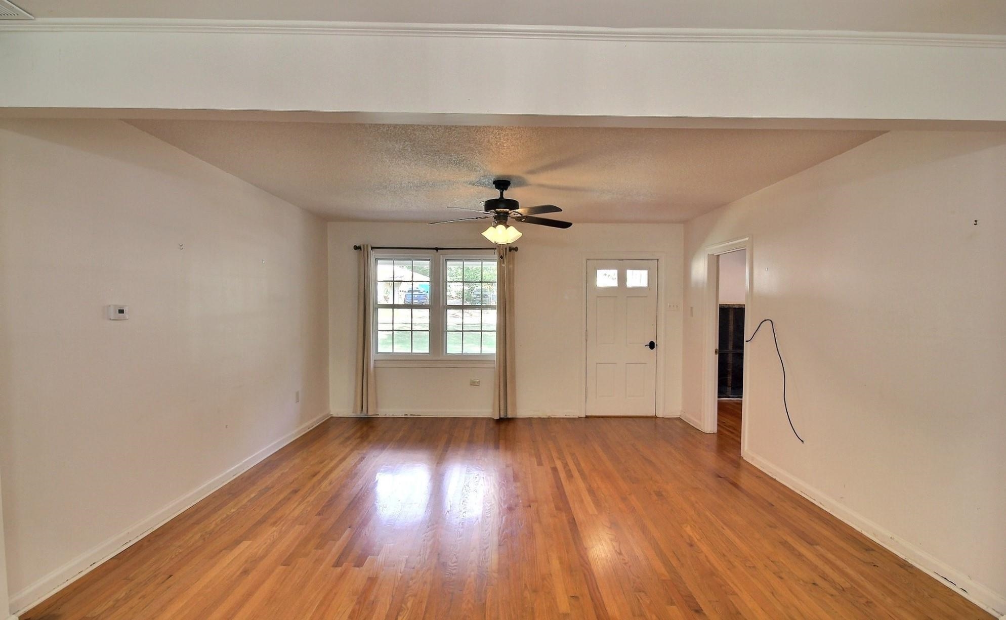 487 South Center Street Collierville, TN 38017 - Photo 5 of 25 a view of empty room with wooden floor and fan