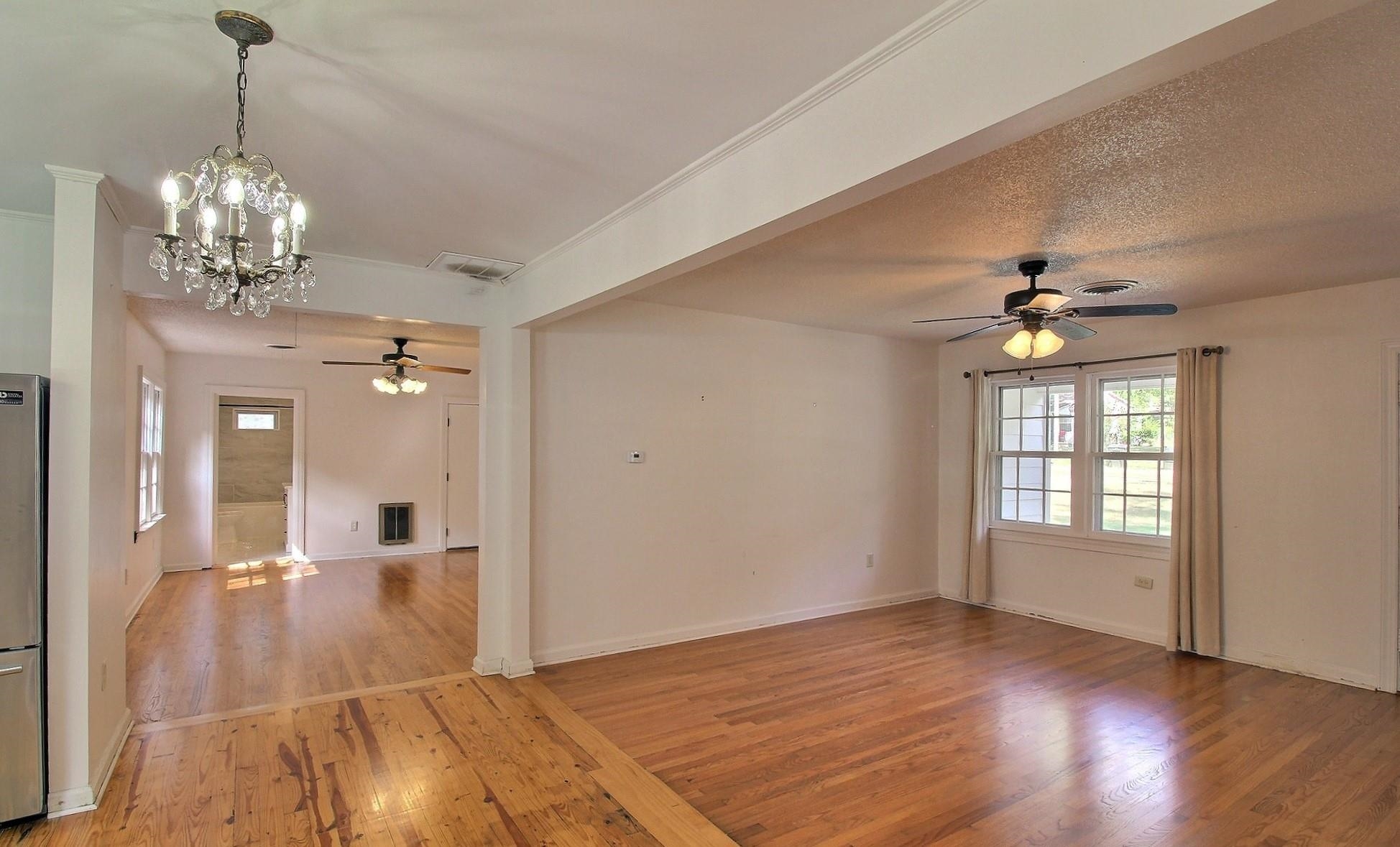 487 South Center Street Collierville, TN 38017 - Photo 6 of 25 a view of a livingroom with a chandelier fan and windows