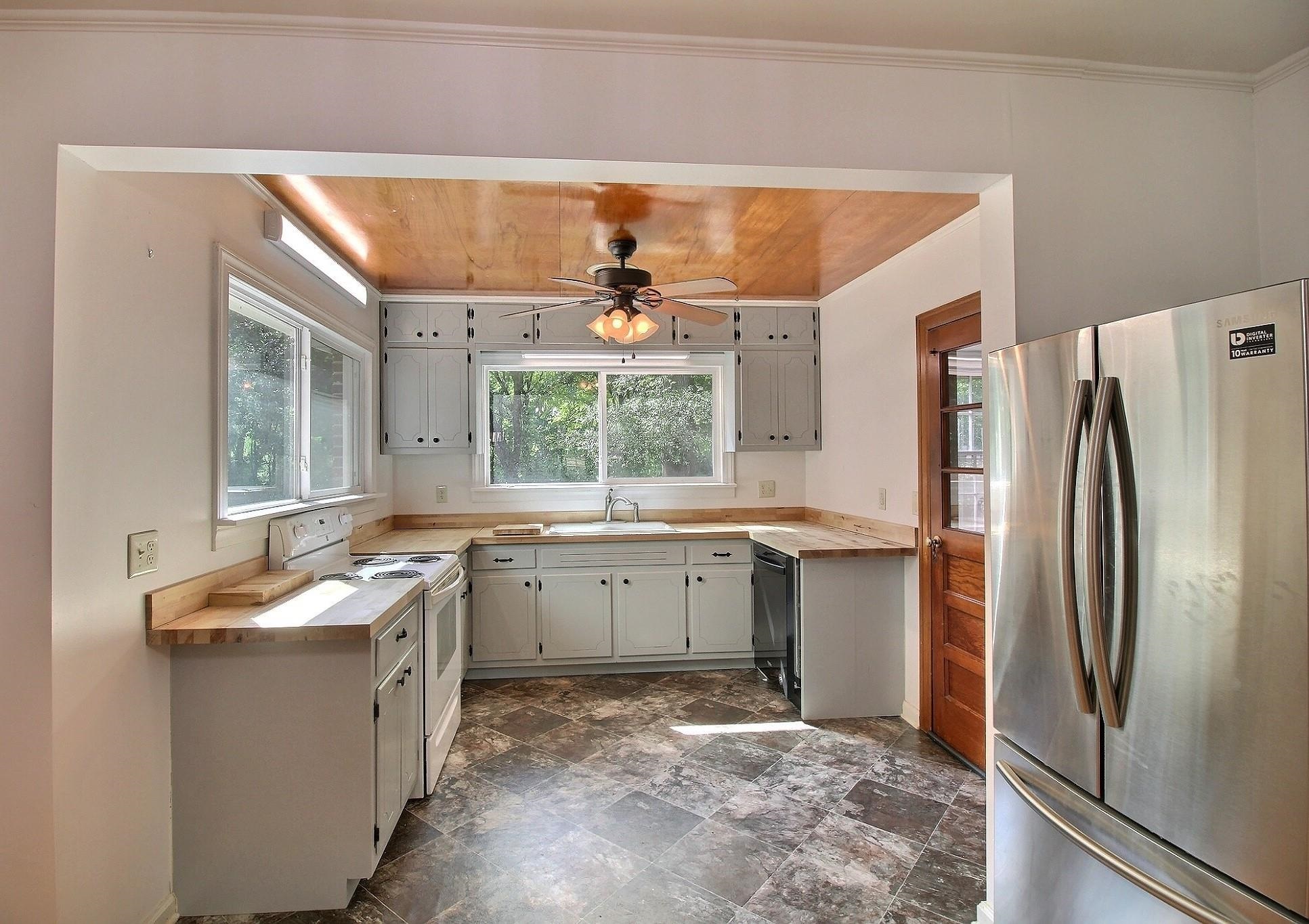 487 South Center Street Collierville, TN 38017 - Photo 9 of 25 a kitchen with a sink stove and refrigerator