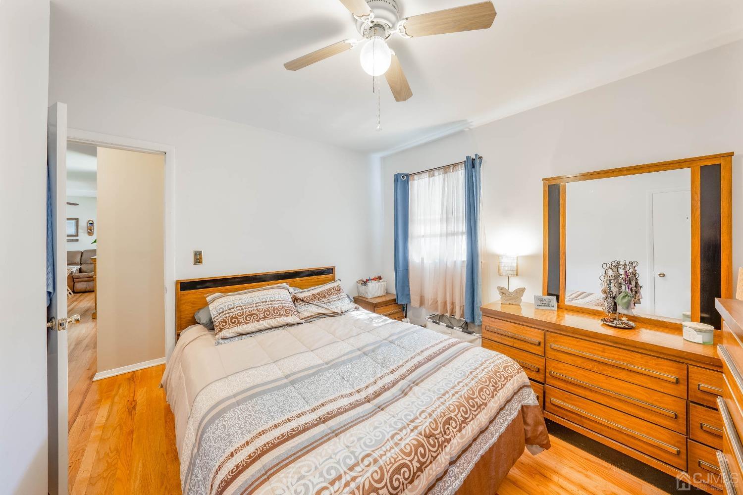 5 Mercer Road Old Bridge, NJ 08857 - Photo 17 of 27 a bedroom with a bed and a chandelier