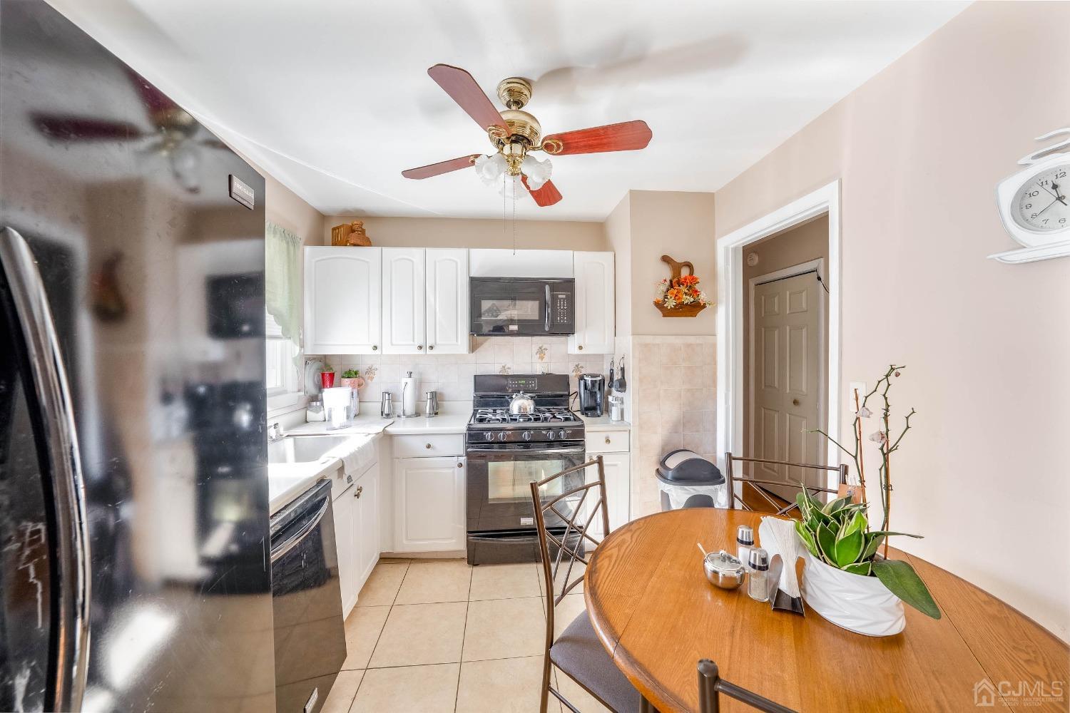 5 Mercer Road Old Bridge, NJ 08857 - Photo 9 of 27 a kitchen with stainless steel appliances granite countertop a refrigerator a sink dishwasher a stove a dining table and chairs with wooden floor