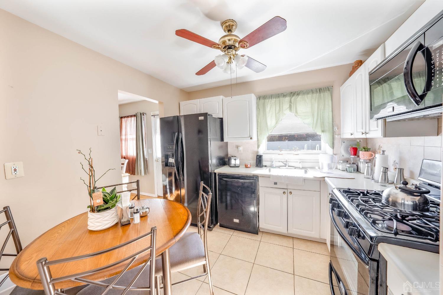 5 Mercer Road Old Bridge, NJ 08857 - Photo 10 of 27 a kitchen with stainless steel appliances granite countertop a stove a sink dishwasher and a refrigerator with wooden floor