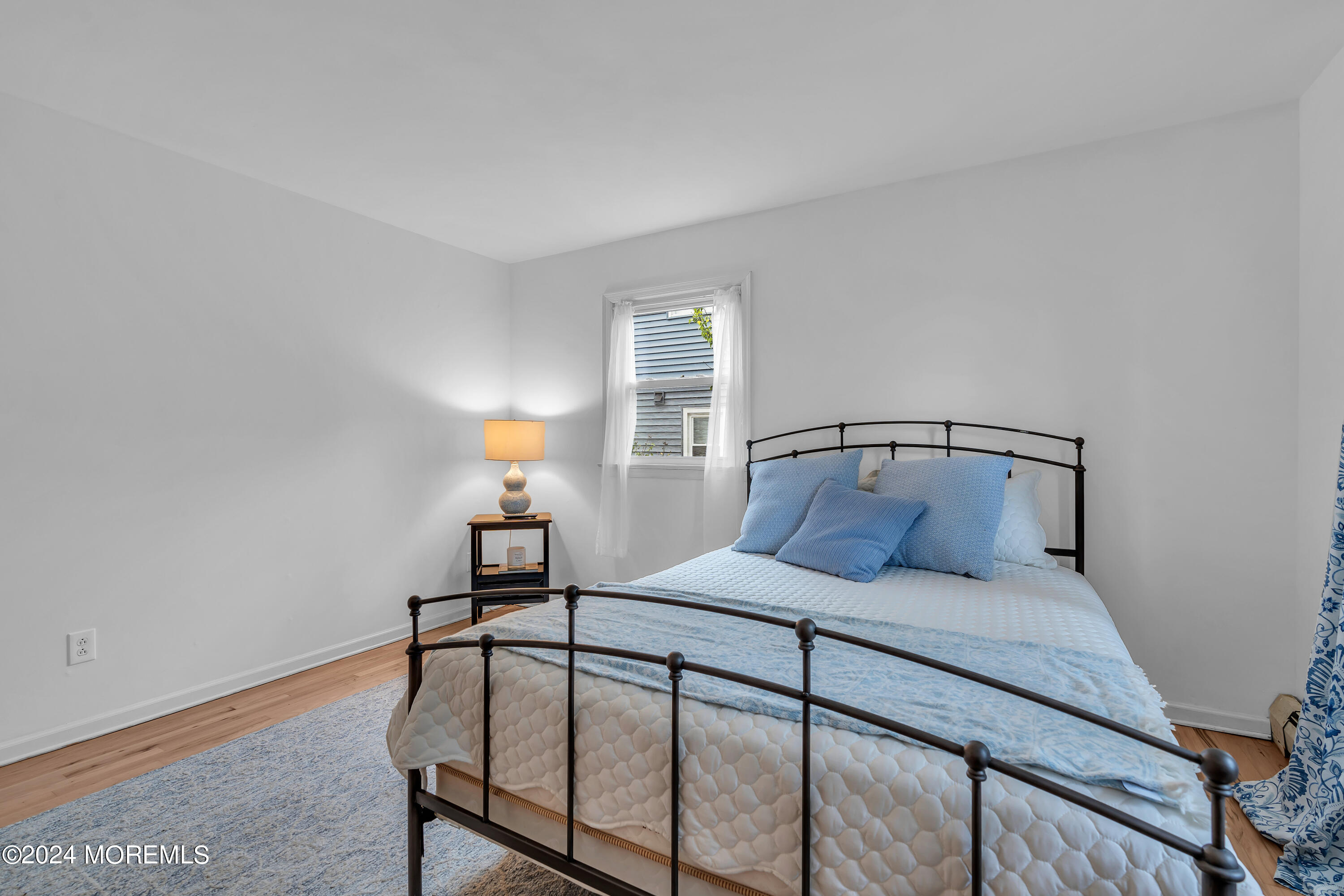 2600 River Road Point Pleasant, NJ 08742 - Photo 27 of 67 a bedroom with a bed and a lamp on table
