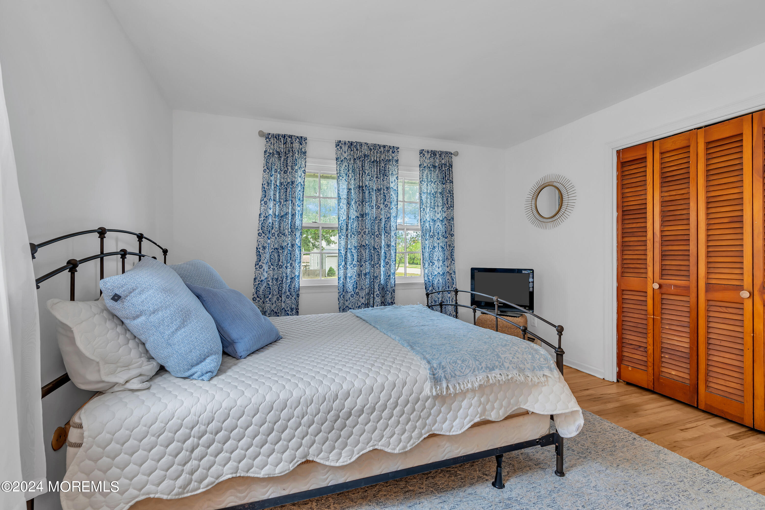 2600 River Road Point Pleasant, NJ 08742 - Photo 28 of 67 a bedroom with a bed a stove and potted plants