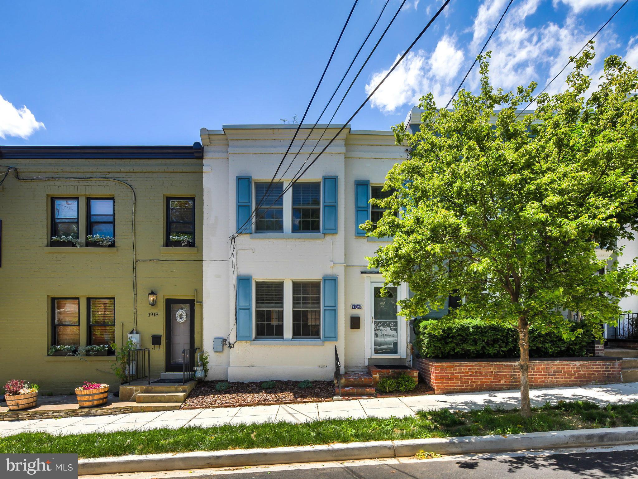 1920 35th Place Northwest Washington, DC 20007 - Photo 1 of 30 a front view of a house with a yard