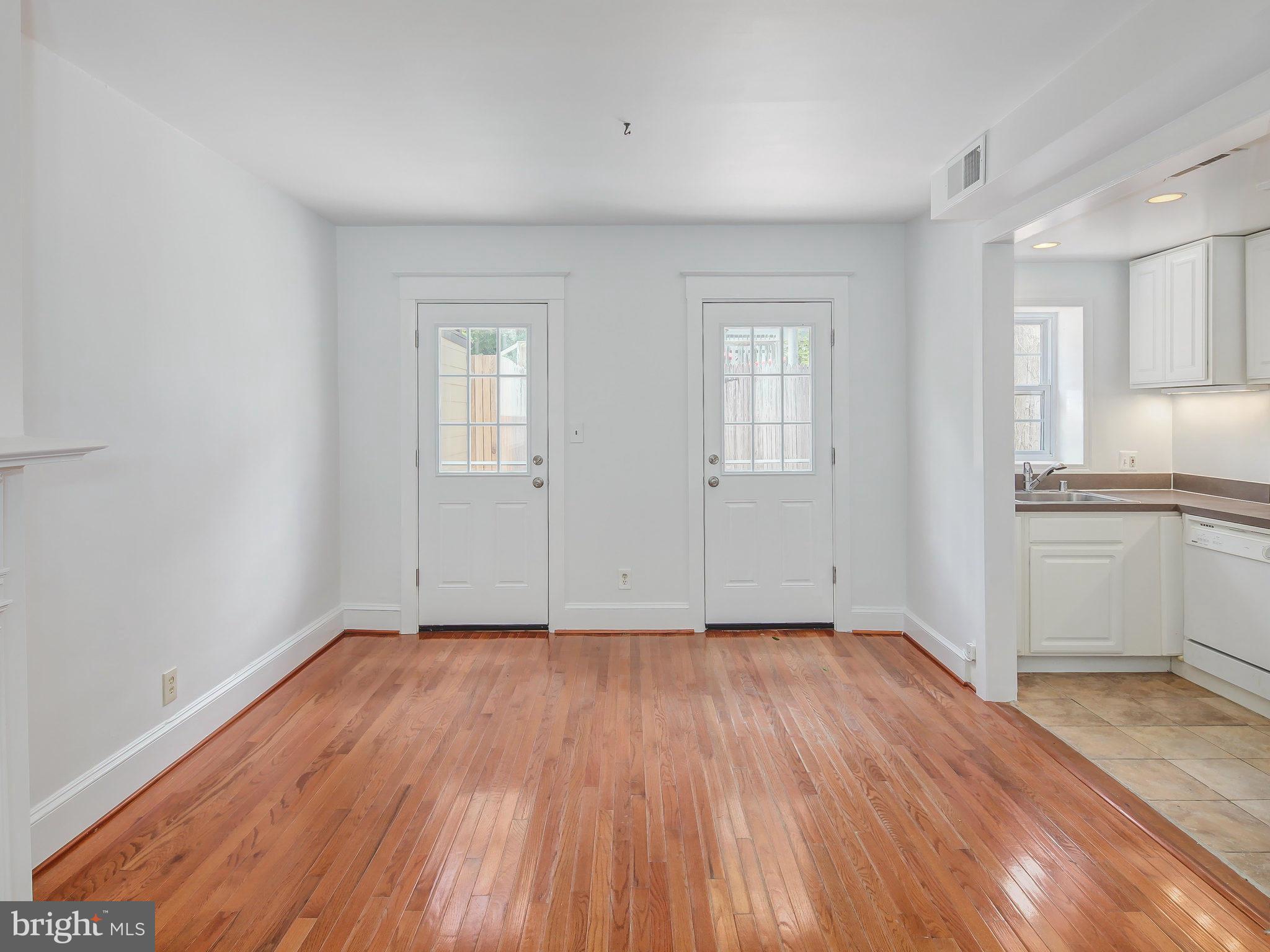 1920 35th Place Northwest Washington, DC 20007 - Photo 11 of 30 an empty room with wooden floor cabinet and windows