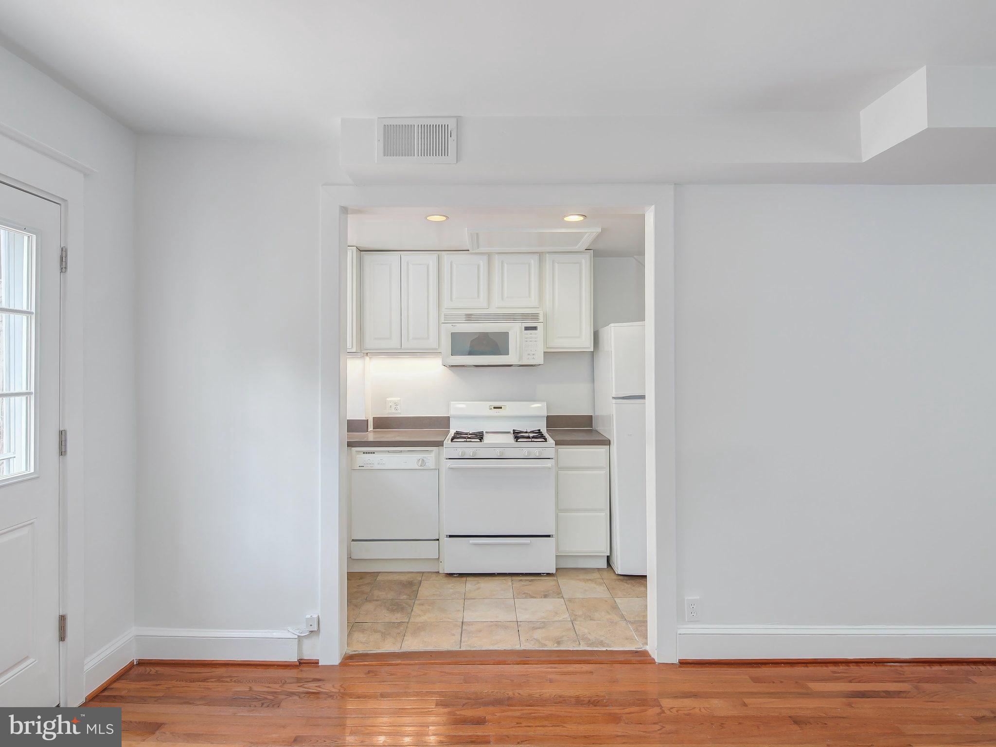 1920 35th Place Northwest Washington, DC 20007 - Photo 13 of 30 a kitchen with stainless steel appliances granite countertop a sink and a stove top oven