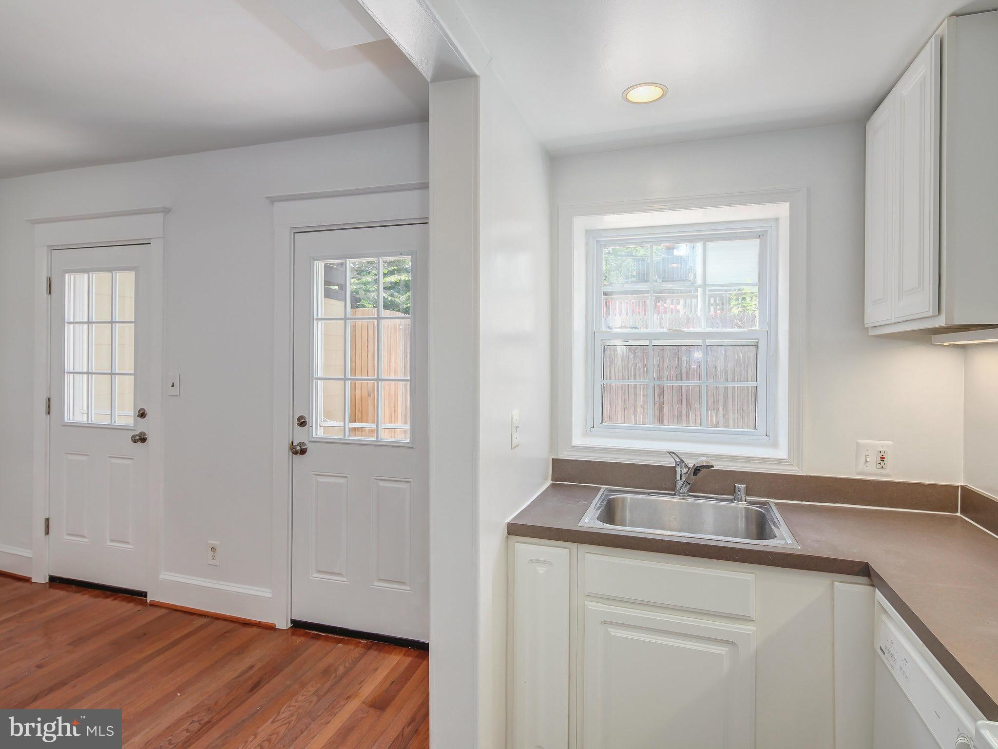 1920 35th Place Northwest Washington, DC 20007 - Photo 17 of 30 a kitchen with a sink cabinets and a window