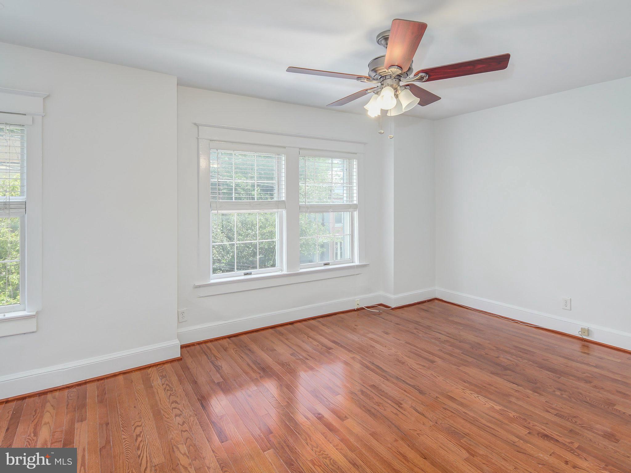 1920 35th Place Northwest Washington, DC 20007 - Photo 20 of 30 a view of an empty room with wooden floor and a window