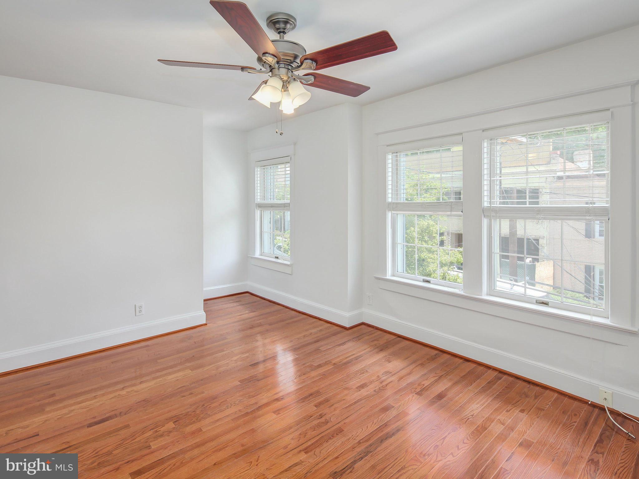 1920 35th Place Northwest Washington, DC 20007 - Photo 21 of 30 a view of an empty room with wooden floor and a window