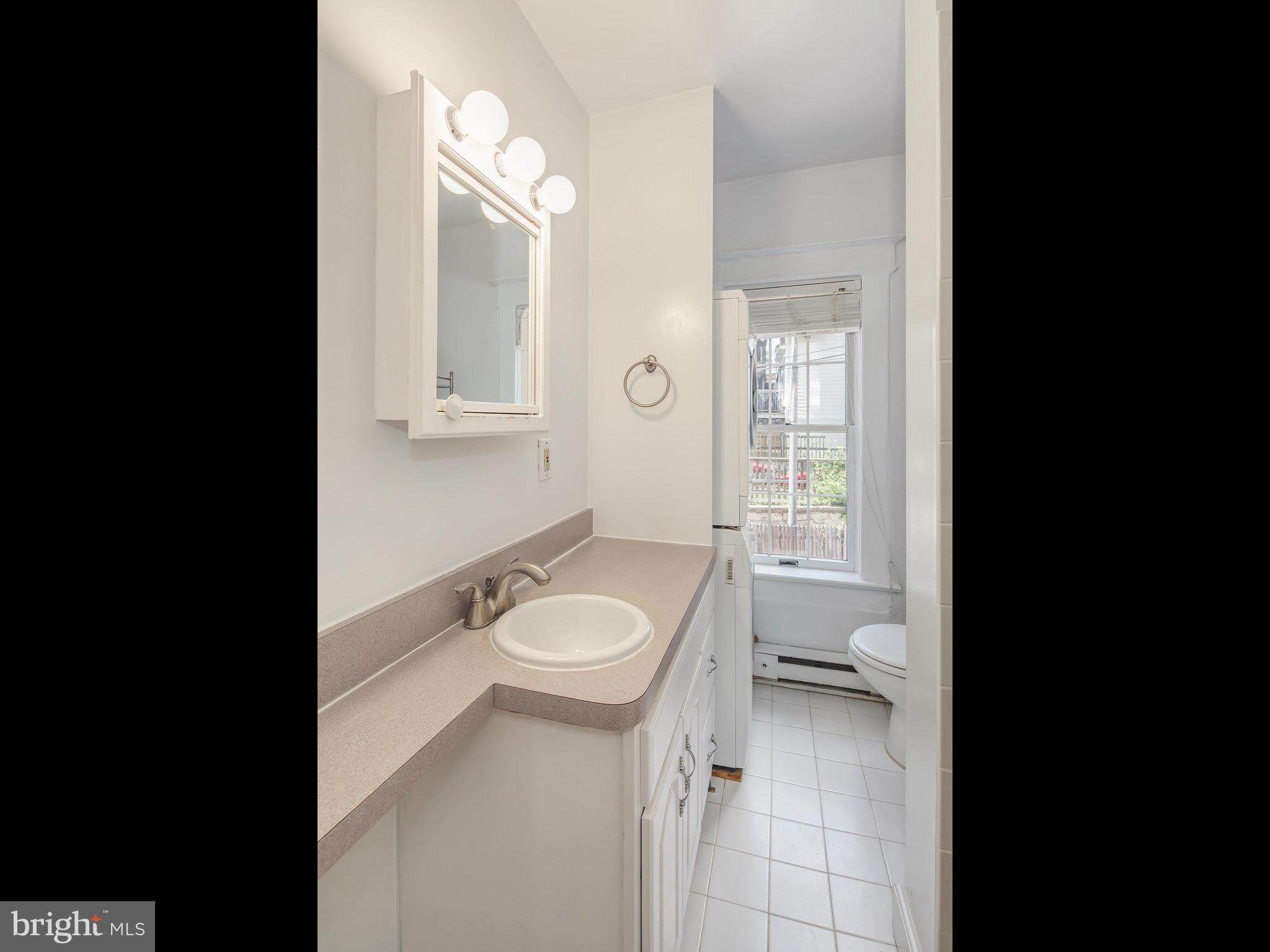 1920 35th Place Northwest Washington, DC 20007 - Photo 23 of 30 a bathroom with a granite countertop toilet sink and mirror