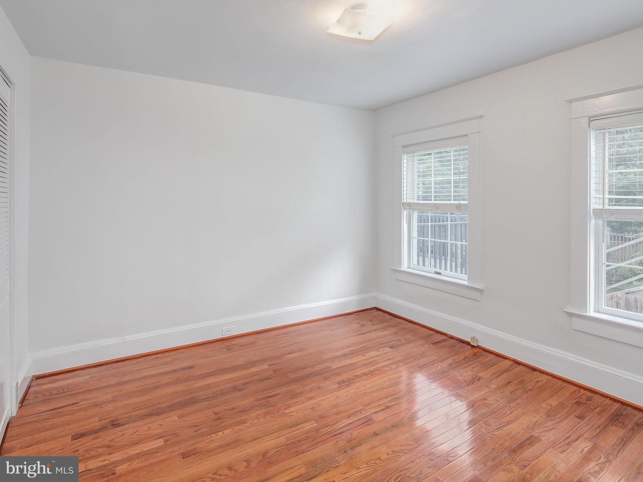 1920 35th Place Northwest Washington, DC 20007 - Photo 26 of 30 an empty room with wooden floor and windows