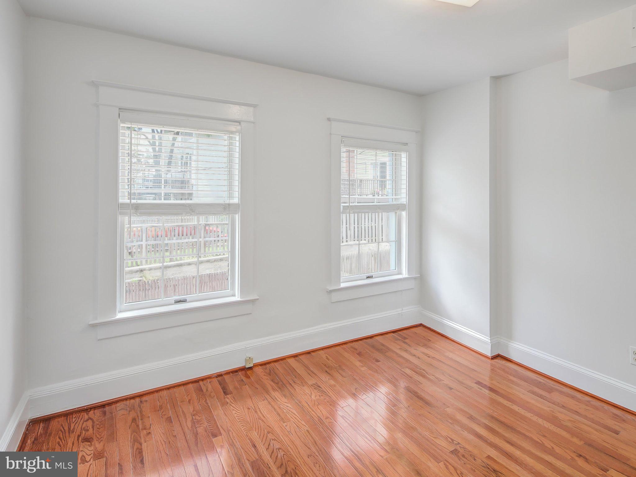 1920 35th Place Northwest Washington, DC 20007 - Photo 27 of 30 an empty room with wooden floor and windows