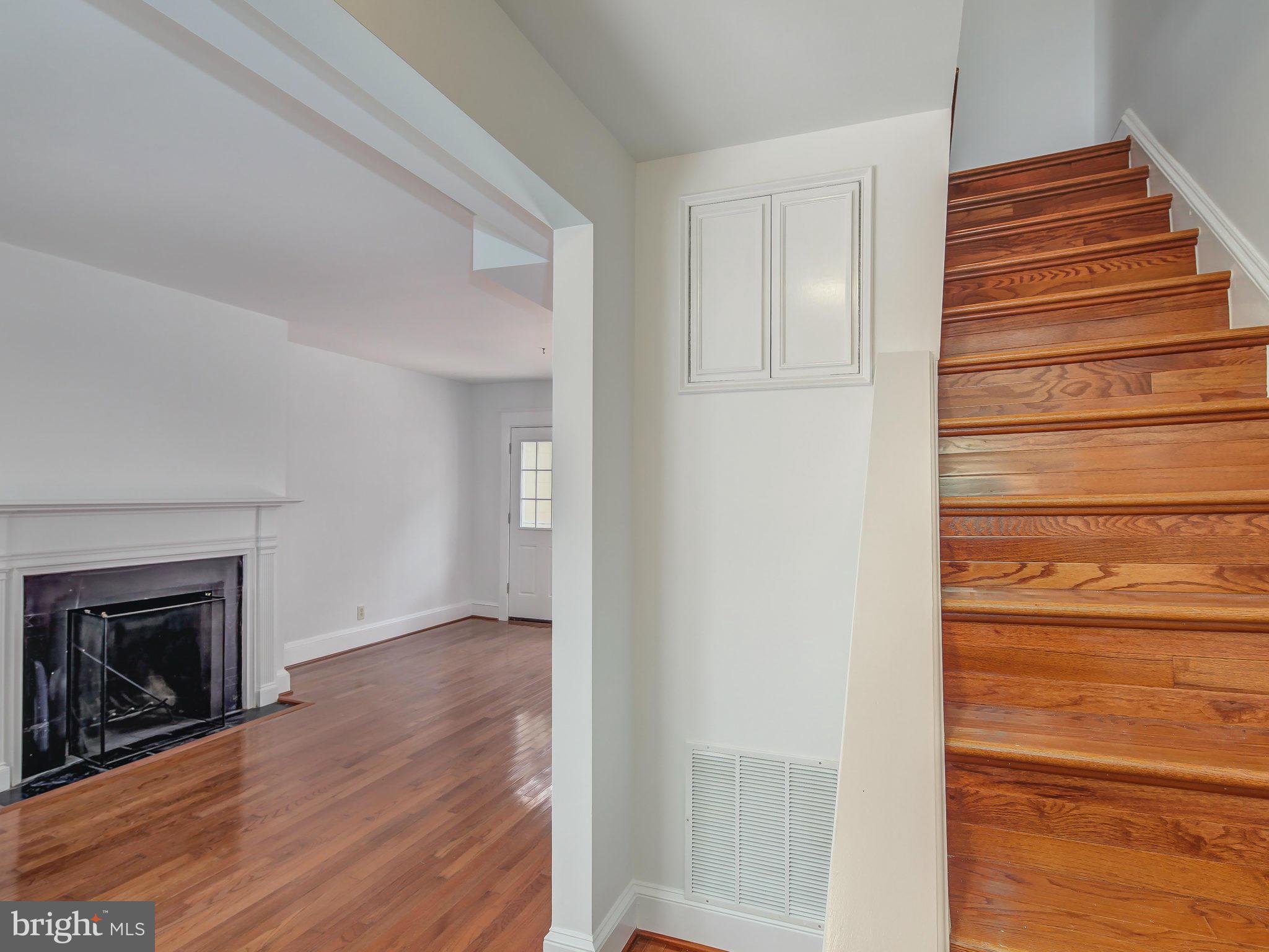 1920 35th Place Northwest Washington, DC 20007 - Photo 5 of 30 a view of a livingroom with wooden floor and a fireplace