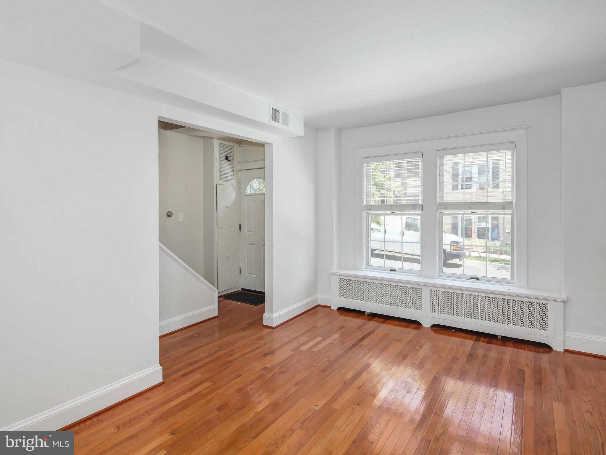 1920 35th Place Northwest Washington, DC 20007 - Photo 6 of 30 an empty room with wooden floor and windows