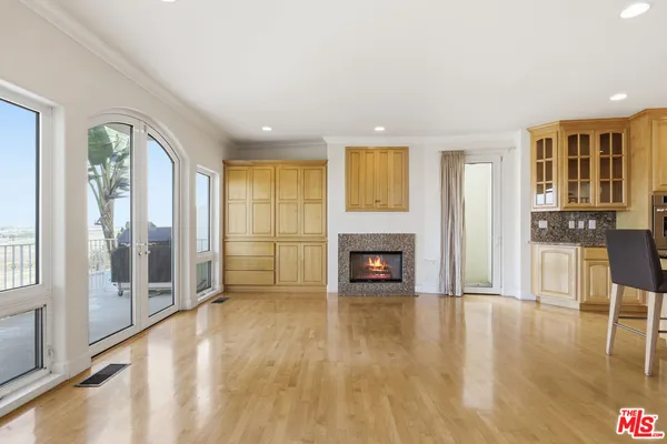a kitchen with granite countertop a stove a sink dishwasher a refrigerator and cabinets with wooden floor