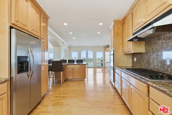 a view of an empty room with window and fire place