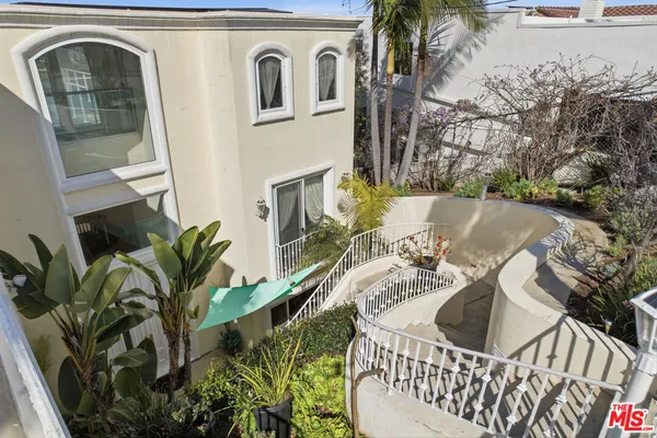 an aerial view of a residential apartment building with a yard