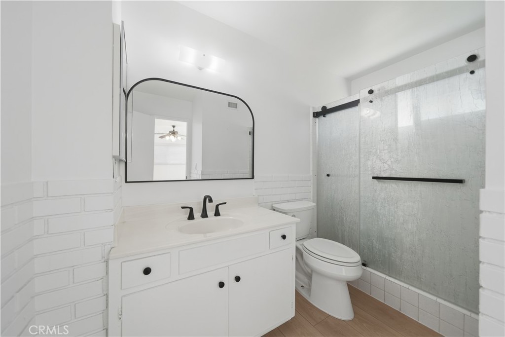 11709 Pounds Avenue Whittier, CA 90604 - Photo 24 of 39 a bathroom with a toilet sink a mirror and shower